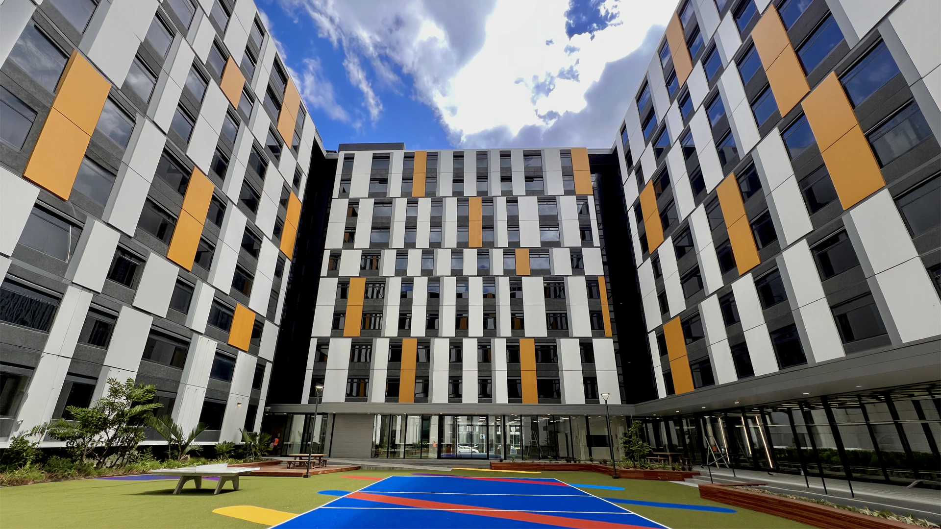 Courtyard with Grey, White and Yellow ECOTONE colour finishes to precast panels