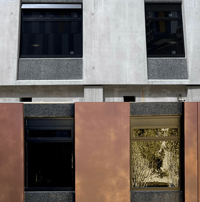 Before/After of grey precast concrete with aggregate only coloured in an ECOTONE Charcoal vs completed panel onsite.